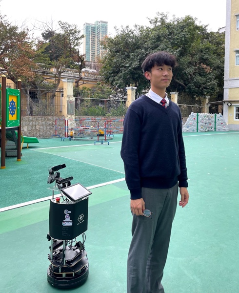 Fall-detection robot prototype beside a student outdoors