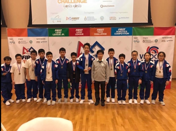 FTC robotics team at a FIRST event with medals