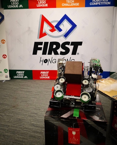 FTC competition robot in front of a FIRST event display