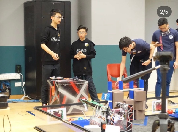 FTC robots and team members at the competition field